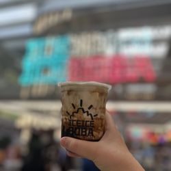 Dirty brown milk, tea, small in front of the ice ice boba logo.