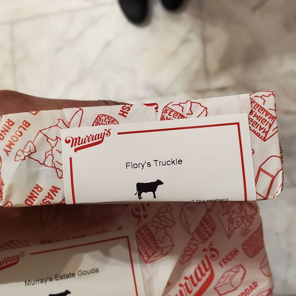 Murray's Cheese - Bleecker - a person holding a box of cheese - Cheese Shops Near Me - New York, New York Murray's Cheese - Bleecker - a person holding a box of cheese - Cheese Shops Near Me - New York, New York