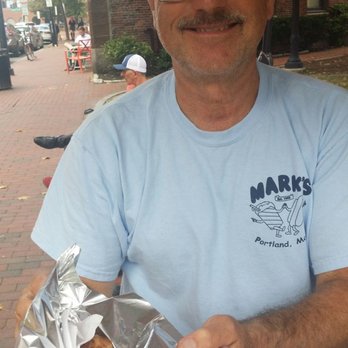 Marks Hotdogs - a man holding a hotdog - Street Vendors Near Me - Portland, Maine Marks Hotdogs - a man holding a hotdog - Street Vendors Near Me - Portland, Maine