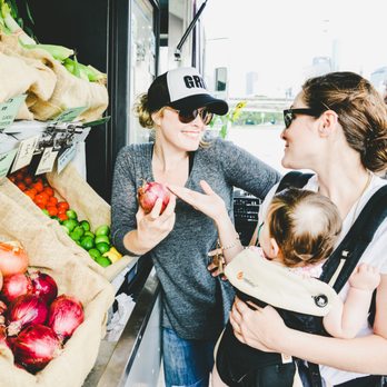 Grit Grocery - a woman with a baby in a carrier and a woman with a baby in a carrier - Grocery Near Me Grit Grocery - a woman with a baby in a carrier and a woman with a baby in a carrier - Grocery Near Me