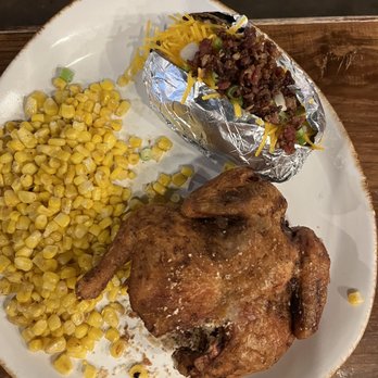 Kitchen Tales - a plate of chicken, corn, and a baked potato - American Near Me - Conroe, Texas
