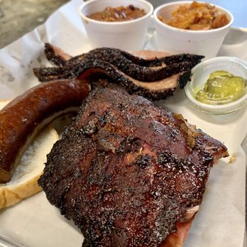 Smoked - Brisket, ribs, sausage with sides of sweet potatoes and baked beans. Slice of bread and pickles included on plates! - Barbeque Near Me - Harahan, Louisiana
