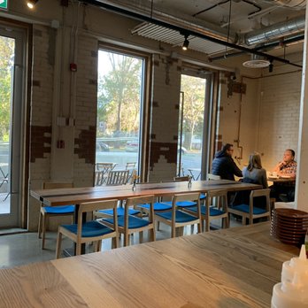Iconoclast Coffee Roasters - two people sitting at a table - Coffee Roasteries Near Me - Edmonton, Alberta Iconoclast Coffee Roasters - two people sitting at a table - Coffee Roasteries Near Me - Edmonton, Alberta
