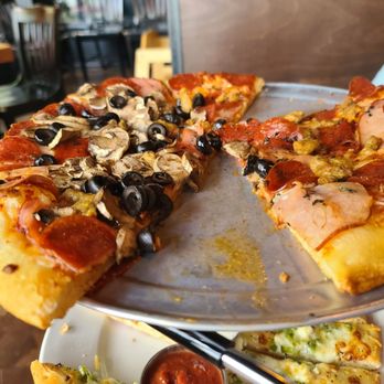 A Pizza Mart - a half eaten pizza on a plate - Pizza Near Me - Seattle, Washington A Pizza Mart - a half eaten pizza on a plate - Pizza Near Me - Seattle, Washington