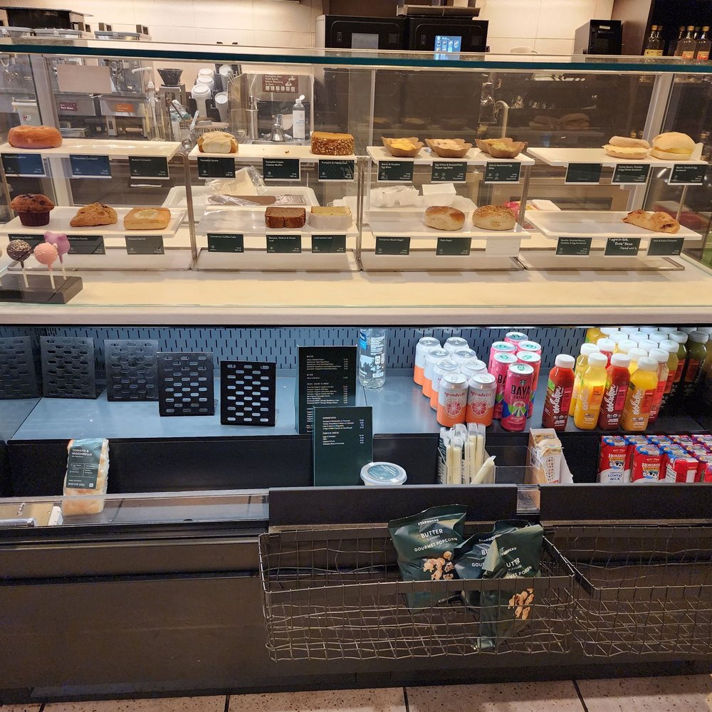 Starbucks - a display case with a variety of drinks and pastries - Coffee & Tea Near Me - Austin, Texas Starbucks - a display case with a variety of drinks and pastries - Coffee & Tea Near Me - Austin, Texas