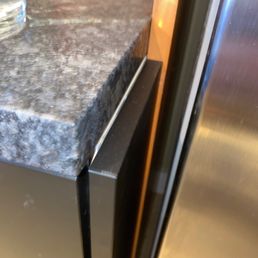 New counter does not cover cabinet end panel.