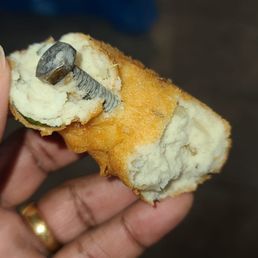 a person holding a piece of food a person holding a piece of food