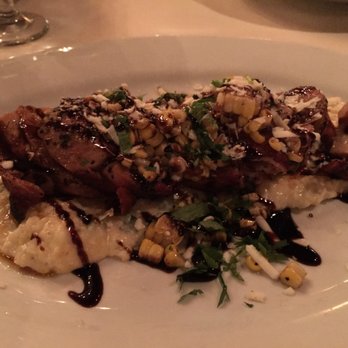 Roaring Fork - Bacon wrapped pork tenderloin over cheese grits, finished with Mexican street corn. - American Near Me - Austin, Texas Roaring Fork - Bacon wrapped pork tenderloin over cheese grits, finished with Mexican street corn. - American Near Me - Austin, Texas
