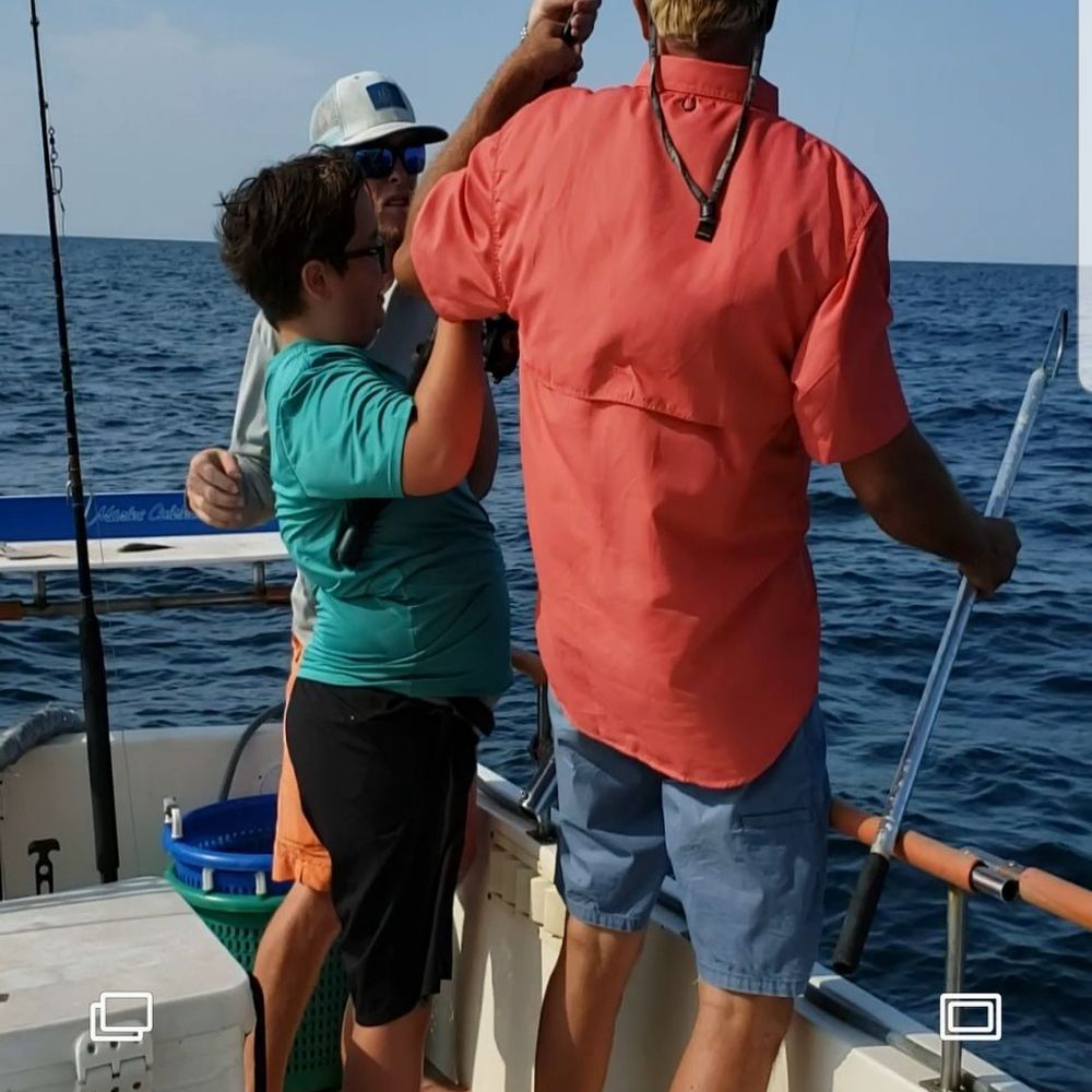 Captain Blacks Fishing - Captain Black, Tyler, and my son working at a 7ft barracuda!!! - Fishing Near Me - Panama City, Florida