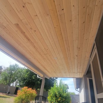 First Priority Renovations - a covered porch with rocking chairs - General Contractors Near Me