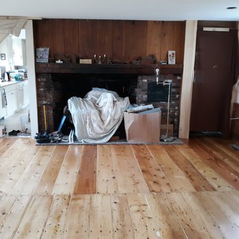 R H Flooring & Remodeling - a living room with wood floors and a fireplace - Flooring Near Me R H Flooring & Remodeling - a living room with wood floors and a fireplace - Flooring Near Me