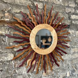 Grand Inspired - "Sun Mirror" made with oak, purple heart and brazilian cherry woods.  Available in the gallery.