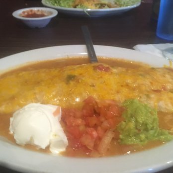 Los Alcatraces Mexican Restaurant - Shredded Beef Burrito smothered in green chili with sour cream, tomatoes and guacamole.  It was good! - Mexican Near Me - Aurora, Colorado