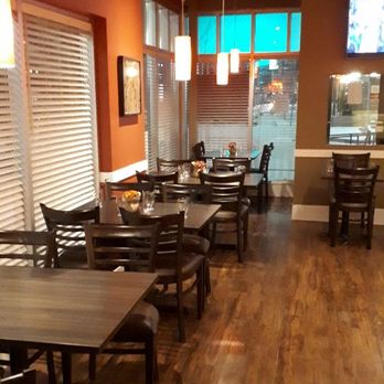 Indique-Nolan Hill - a dining area with tables and chairs - Indian Near Me - Calgary, Alberta