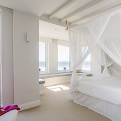Latitude50 - Master bedroom overlooking Polzeath beach at Tristram, a self-catering holiday home in North Cornwall