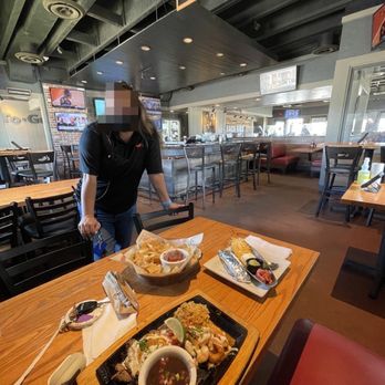 Chili's - a man preparing food in a restaurant - Bars Near Me - Corsicana, Texas