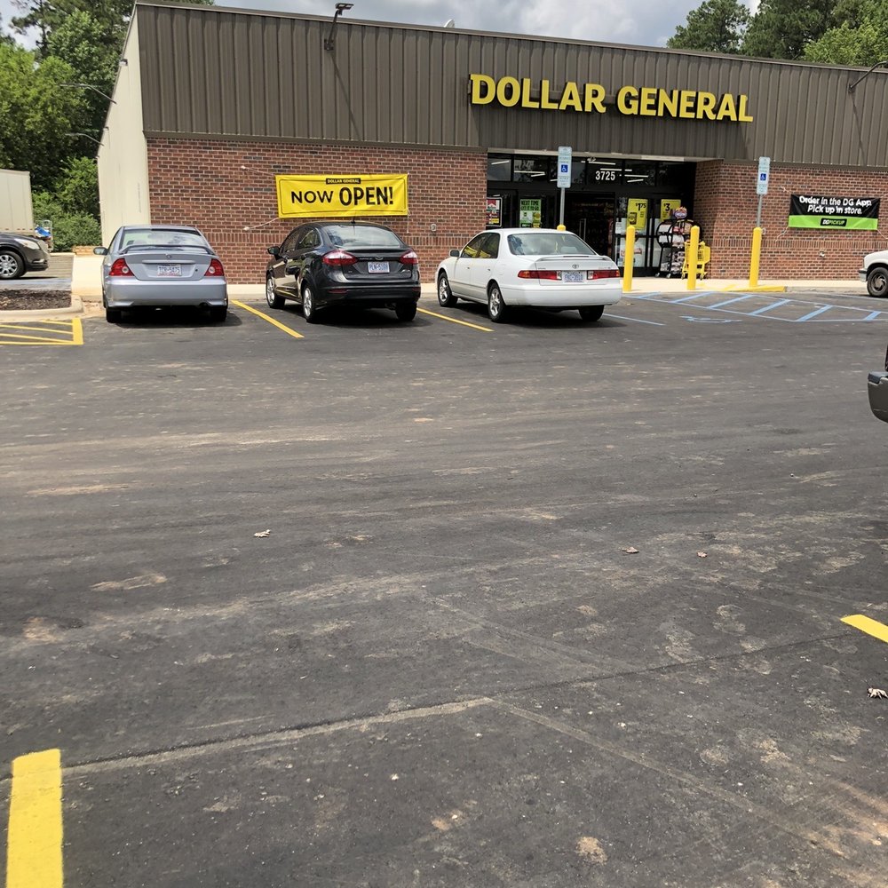 Dollar General - a parking lot with cars parked in front of a dollar general store - Discount Store Near Me - Louisburg, North Carolina