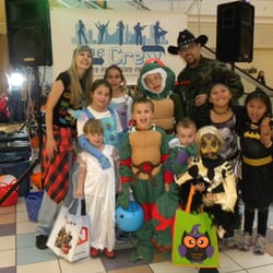 The Crew - Taking a group photo with kids in costume at one of our Halloween Events.
