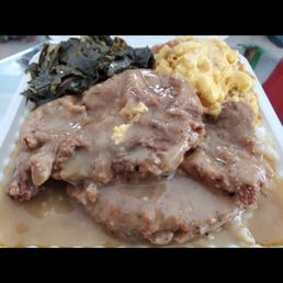 Smothered pork chops w/rice, greens and mac & cheese