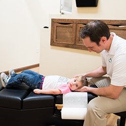 Blue Apple Walk In Chiropractic - Bismarck - Dr. Aaron Patchen adjusting a patient
