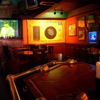 Irish Rover - a bar with a television and darts on the wall - Sports Bars Near Me - Astoria, New York