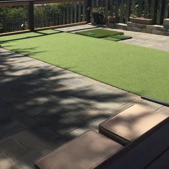 Tin Landscaping - a patio with artificial turf and a putting hole - Landscaping Near Me Tin Landscaping - a patio with artificial turf and a putting hole - Landscaping Near Me