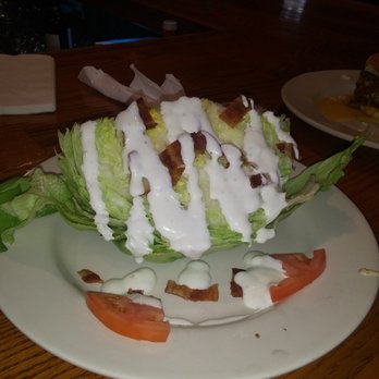 The Barrel House - a salad with dressing on a plate - American Near Me - Maysville, Kentucky The Barrel House - a salad with dressing on a plate - American Near Me - Maysville, Kentucky