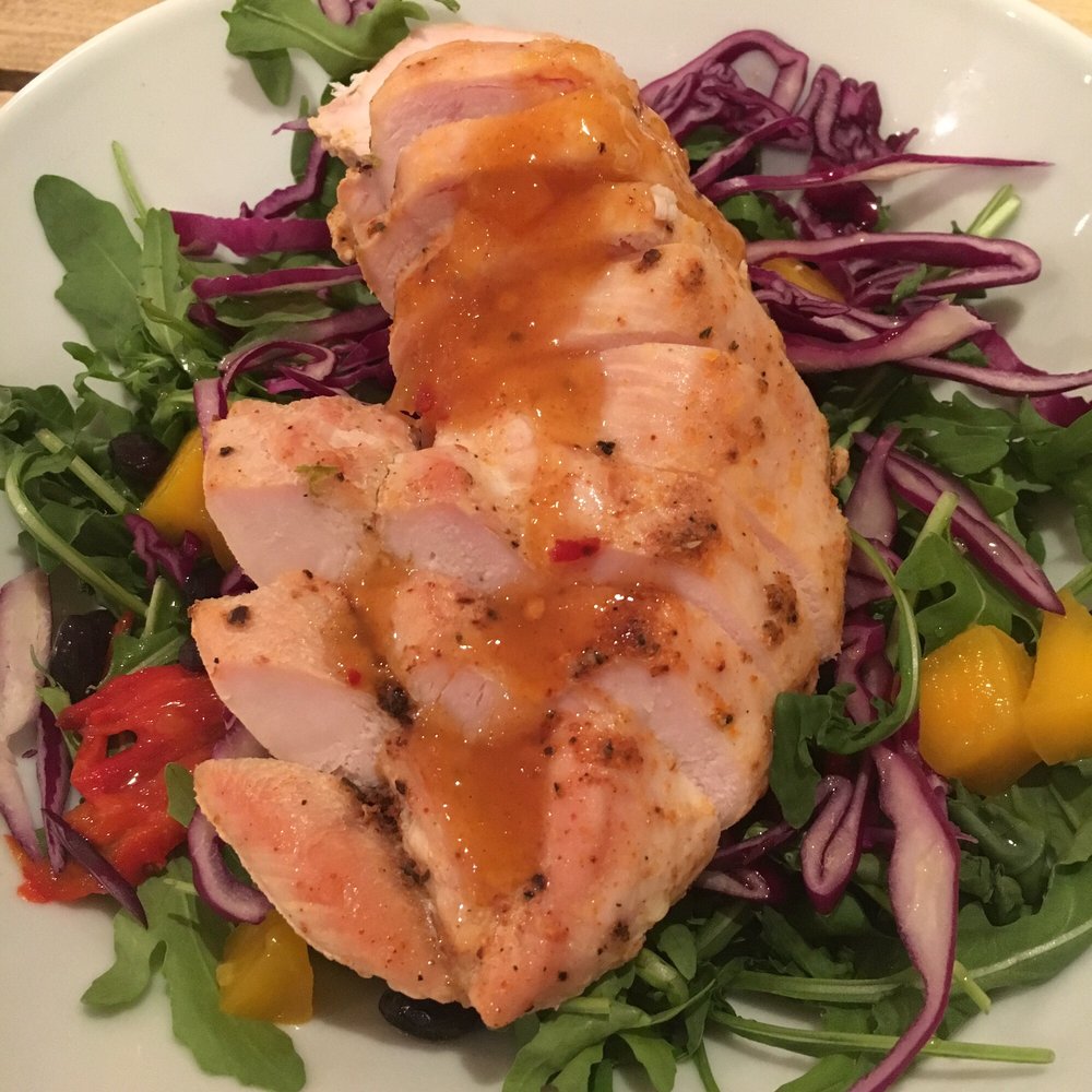 Chipotle chicken with mango, black beans, salad and peppers.