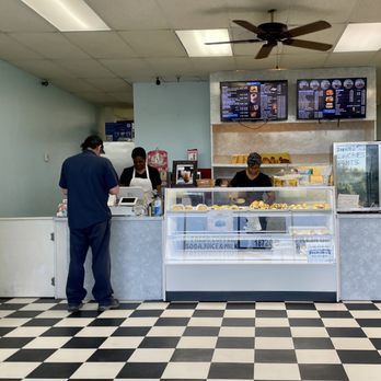 MX Donuts - a man and a woman standing in front of a counter - Donuts Near Me - Houston, Texas