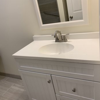 Batour Home Improvement - a bathroom with a sink and mirror - General Contractors Near Me Batour Home Improvement - a bathroom with a sink and mirror - General Contractors Near Me