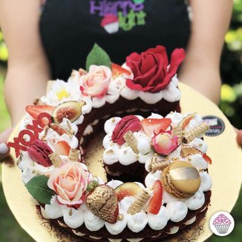 Hierro Light - a woman holding a cake - Desserts Near Me - Doral, Florida