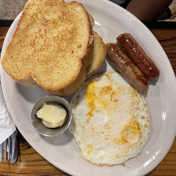 The Roost - The rooster with French toast and sausage links. - Breakfast & Brunch Near Me - Lawrence, Kansas The Roost - The rooster with French toast and sausage links. - Breakfast & Brunch Near Me - Lawrence, Kansas