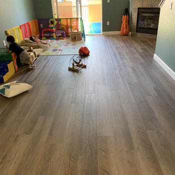 AJ’s Elite Flooring - Living room with new LVP and baseboards - Flooring Near Me AJ’s Elite Flooring - Living room with new LVP and baseboards - Flooring Near Me
