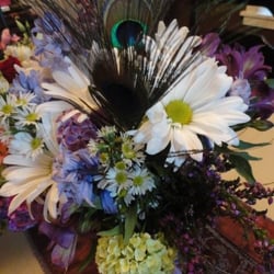Peacock feathers added into my wedding flower arrangements :)