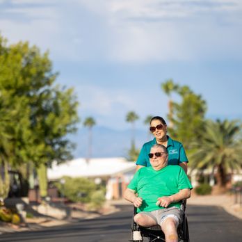 Right at Home - Caregiver assisting client in wheel chair - Home Health Care Near Me - Corona, California Right at Home - Caregiver assisting client in wheel chair - Home Health Care Near Me - Corona, California