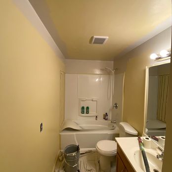 Supreme Painting - Before of a clients bathroom. Changing yellow to grey. Shower surround will be fixed. - Painters Near Me