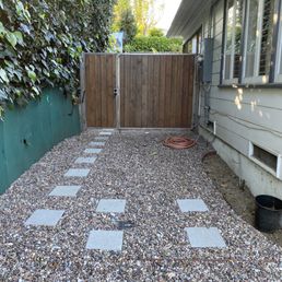 Pathway and gravel, with new drainage and a repaired fense.