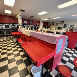 Michigan Coin Laundry - One of the many folding areas. A view of the whole facility.