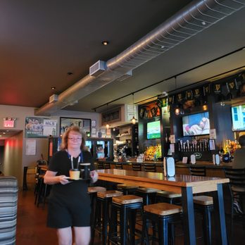 The Brewery Bar & Kitchen - a waitress carrying a tray of food - Sports Bars Near Me - Woodside, New York The Brewery Bar & Kitchen - a waitress carrying a tray of food - Sports Bars Near Me - Woodside, New York