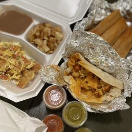 Chorizo, egg, potatoes and cheese tacos. Migas and tamales Chorizo, egg, potatoes and cheese tacos. Migas and tamales