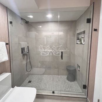 Delta Eden - a bathroom with a glass shower - General Contractors Near Me Delta Eden - a bathroom with a glass shower - General Contractors Near Me