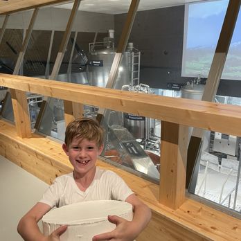Appenzeller Schaukäserei - My son holding a sample wheel of cheese to see how much it weighs. - Cheese Shops Near Me - Stein AR, Arkansas