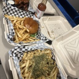 Garlic parmesan fries, chicken wings and tenders  with a hamburger with fries
