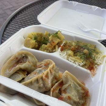 Momo - a container of dumplings and a plate of food - Himalayan/Nepalese Near Me - Crested Butte, Colorado