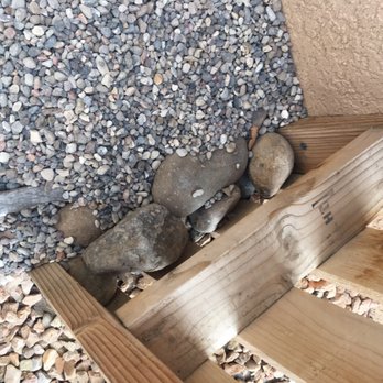 Martinez Design & Scape - Attempted to place large rocks against fence to keep gravel from falling through - Tree Services Near Me
