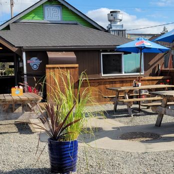 Longhorn Saloon - a patio with tables and umbrellas - Bars Near Me - Bow, Washington