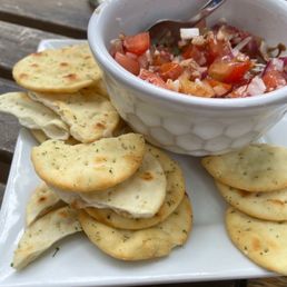a bowl of salsa and crackers