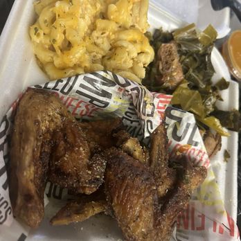 The Licking Orlando - Lemon pepper wings with Mac n cheese and greens. Greens had bones in them - Soul Food Near Me - Orlando, Florida The Licking Orlando - Lemon pepper wings with Mac n cheese and greens. Greens had bones in them - Soul Food Near Me - Orlando, Florida
