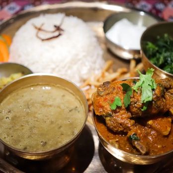 Gorkhali Kitchen Tampa - Goat Thaali: Served with choice of curry, basmati rice, black dal (lentils), potatoes, sauteed mixed greens and achar. - Himalayan/Nepalese Near Me - Tampa, Florida Gorkhali Kitchen Tampa - Goat Thaali: Served with choice of curry, basmati rice, black dal (lentils), potatoes, sauteed mixed greens and achar. - Himalayan/Nepalese Near Me - Tampa, Florida