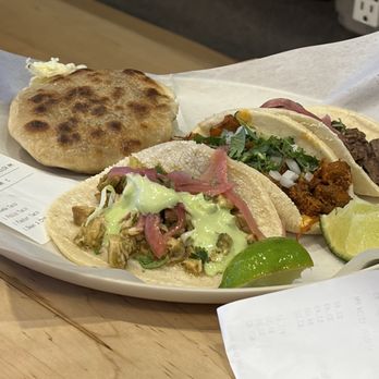 Tacos Chiwas - Gordita on the left and 3 flavors of tacos. Chicken, Carne Asada, and I think it was Pastor. - Mexican Near Me - Phoenix, Arizona